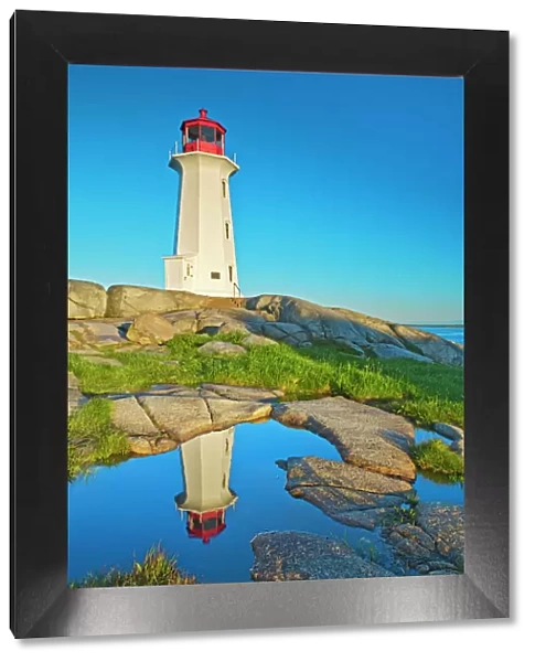 Canada, Nova Scotia. Peggys Cove Lighthouse reflection in water