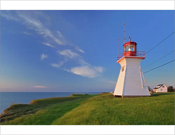Canada, New Brunswick, Cap Lumiere. Richibucto Head Lighthouse and ocean. Credit as