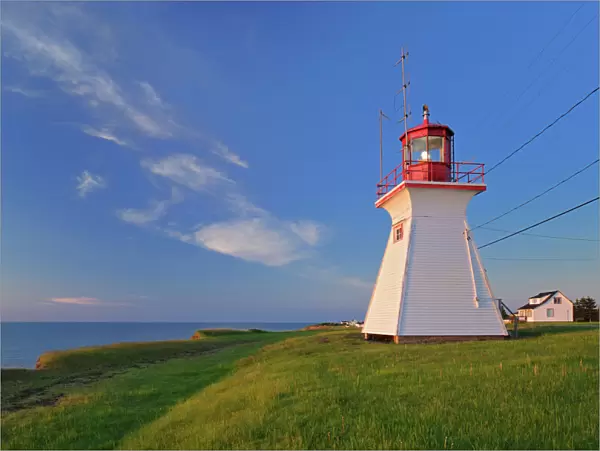 Canada, New Brunswick, Cap Lumiere. Richibucto Head Lighthouse and ocean. Credit as