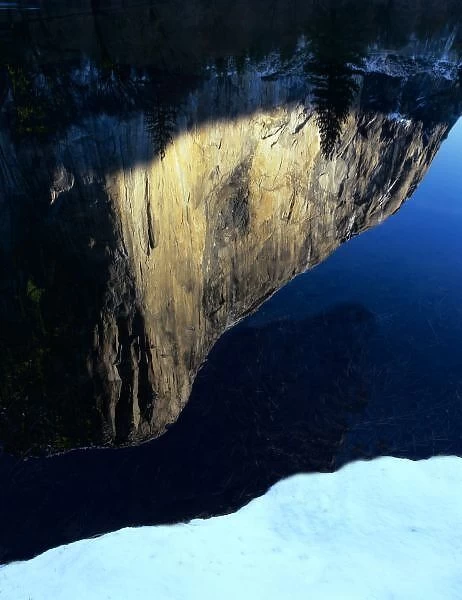 The largest granite rock on Earth reflects in the Merced River