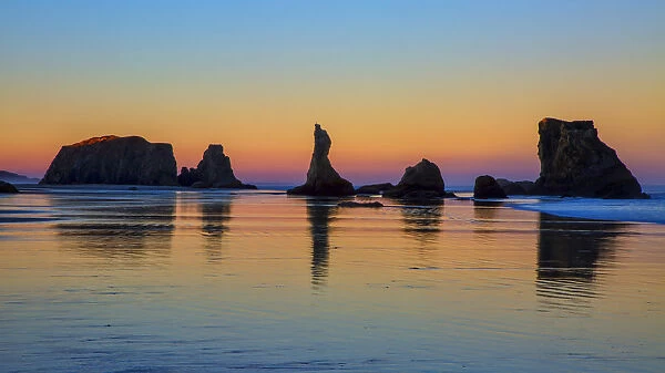 USA, Oregon, Bandon. Sunset on beach sea stacks