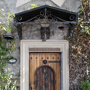 Azerbaijan, Baku. A wooden front door covered with large iron rivets