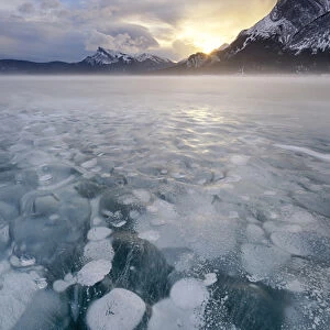 Canada, Alberta, Abraham Lake. Winter sunrise over lake and Mount Michener. Credit as