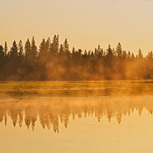 Canada, Manitoba, Riding Mountain National Park. Fog rising above Whirlpool Lake at