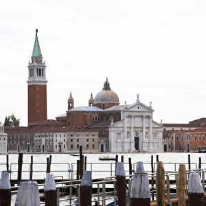 Venice, Veneto, Italy - A church can be seen across the water from a marina dock