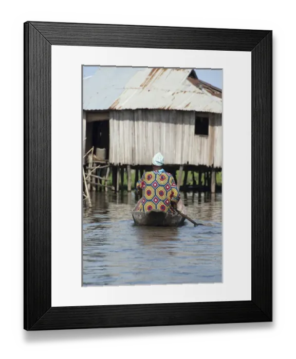 Framed Print : Africa, Benin, Ganvie. Tofinu villager in dugout canoe on the waters of Lake Nokoue