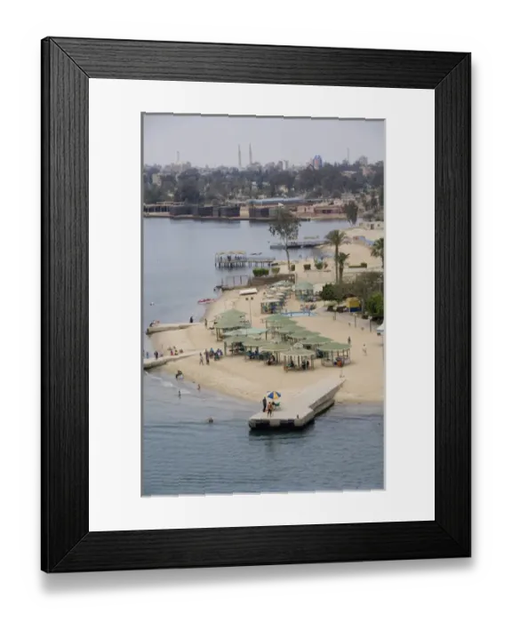Framed Print : Egypt, Suez Canal. Beachfront resort along the canal