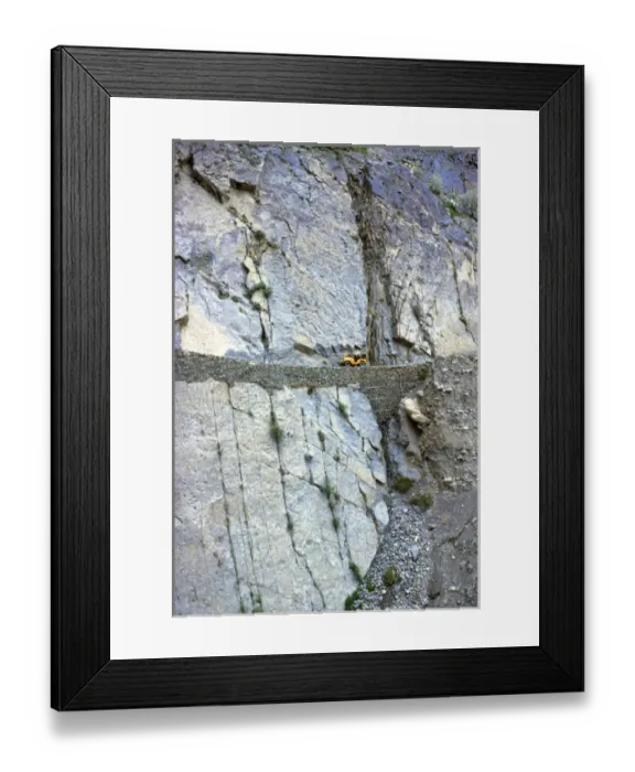 Framed Print : Pakistan, N-W Frontier Province, Hunza Valley. A lone jeep creeps along the narrow Framed Print : Pakistan, N-W Frontier Province, Hunza Valley. A lone jeep creeps along the narrow