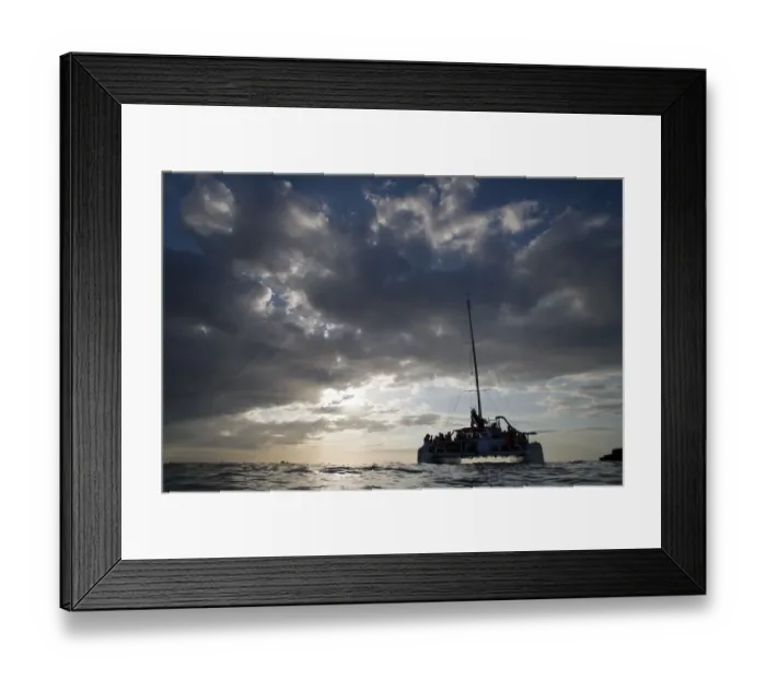 Framed Print : Jamaica, Negril, Low Angle view of tourist catamaran boat near Pirates Cave at sunset Framed Print : Jamaica, Negril, Low Angle view of tourist catamaran boat near Pirates Cave at sunset