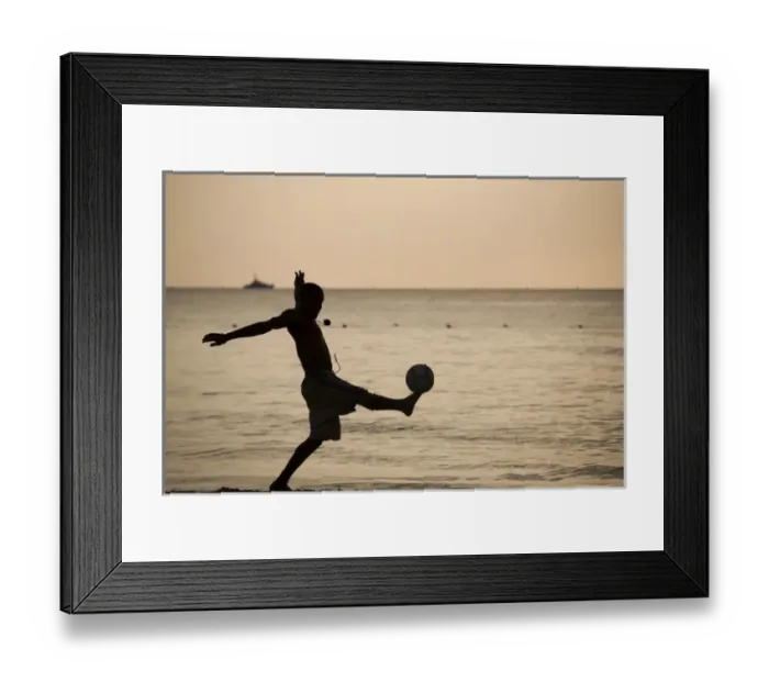 Framed Print : Jamaica, Negril, Silhouette of young men playing soccer along Caribbean Sea Framed Print : Jamaica, Negril, Silhouette of young men playing soccer along Caribbean Sea