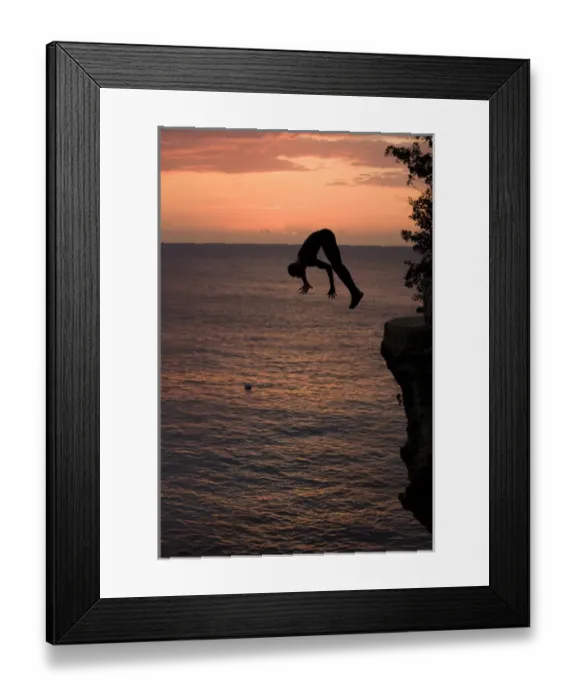 Framed Print : Jamaica, Negril, Silhouette of young man leaping from from cliff above Pirates Cave Framed Print : Jamaica, Negril, Silhouette of young man leaping from from cliff above Pirates Cave
