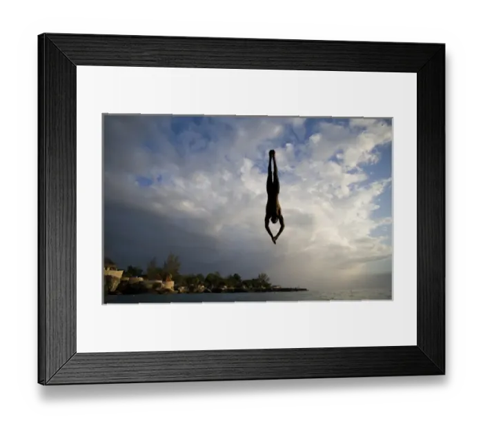 Framed Print : Jamaica, Negril, Silhouette of young man leaping from from cliff above Pirates Cave Framed Print : Jamaica, Negril, Silhouette of young man leaping from from cliff above Pirates Cave