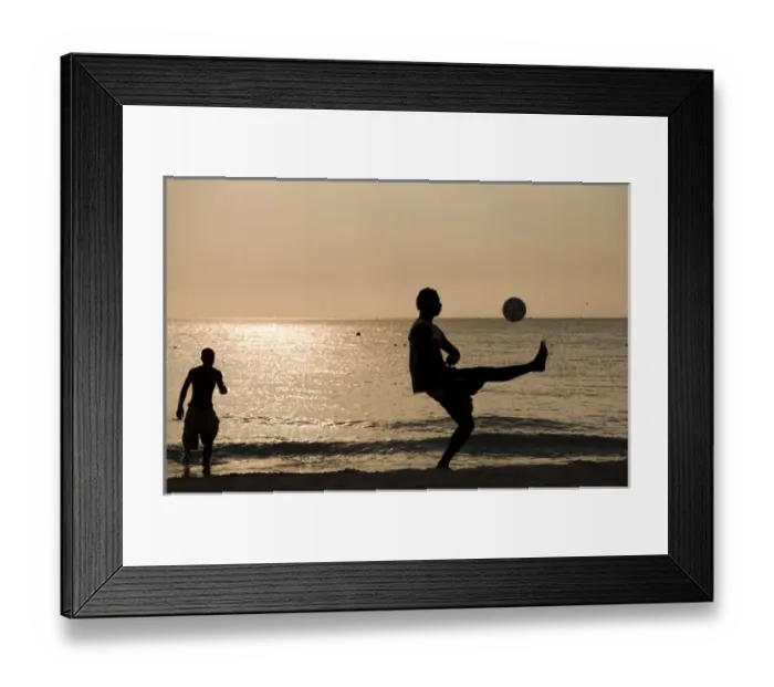 Framed Print : Jamaica, Negril, Silhouette of young men playing soccer along Caribbean Sea Framed Print : Jamaica, Negril, Silhouette of young men playing soccer along Caribbean Sea