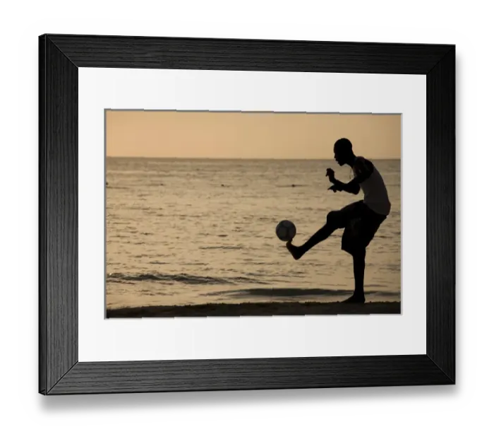 Framed Print : Jamaica, Negril, Silhouette of young men playing soccer along Caribbean Sea Framed Print : Jamaica, Negril, Silhouette of young men playing soccer along Caribbean Sea