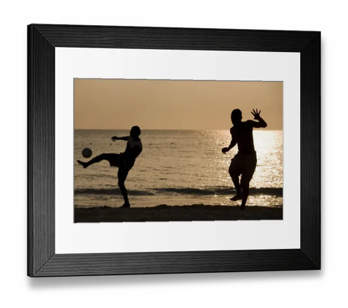 Framed Print : Jamaica, Negril, Silhouette of young men playing soccer along Caribbean Sea Framed Print : Jamaica, Negril, Silhouette of young men playing soccer along Caribbean Sea