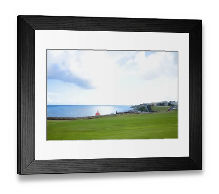 Framed Print : San Juan, Puerto Rico - A large grassy area stretches out leading to a stone wall