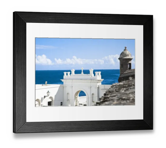 Framed Print : San Juan, Puerto Rico - A white building holds the entrance to a cemetery while above Framed Print : San Juan, Puerto Rico - A white building holds the entrance to a cemetery while above
