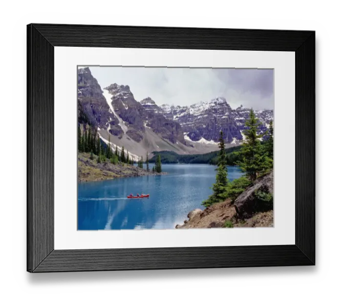 Framed Print : Canada, Alberta, Moraine Lake. A canoe glides across beautiful Moraine Lake in Framed Print : Canada, Alberta, Moraine Lake. A canoe glides across beautiful Moraine Lake in