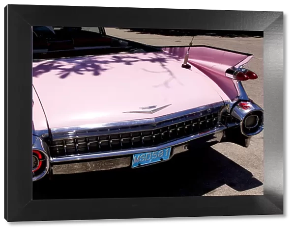 Classic 1959 pink Cadillac convertible on road in beautiful Varadero Beach in Valadero