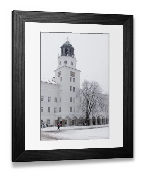 Framed Print : Europe, Austria, Salzburg. Person in snowstorm with red umbrella walking past white building Framed Print : Europe, Austria, Salzburg. Person in snowstorm with red umbrella walking past white building