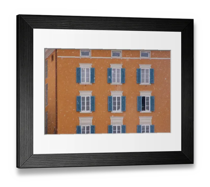 Framed Print : Europe, Austria, Salzburg. Blue shutters on orange apartment building in snowfall