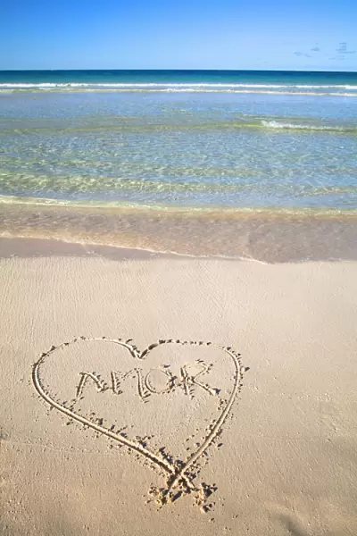 Vieques, Puerto Rico - A heart is drawn in the sand of a beach with the word amor inside