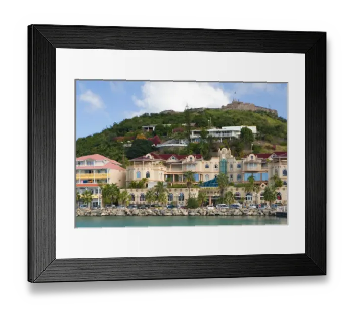 Framed Print : Fort St. Louis sits atop a hill above a modern day luxury shopping mall in Marigot, St