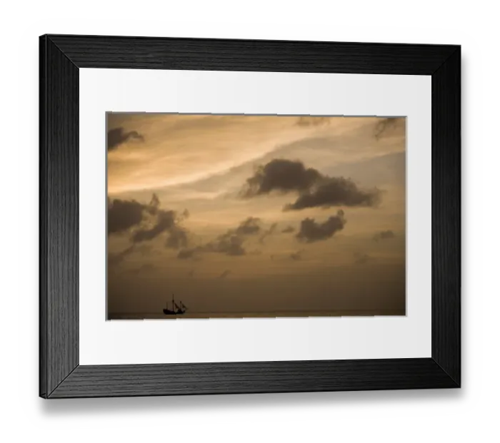 Framed Print : Cayman Islands, Grand Cayman Island, Setting sun silhouettes yacht sailing through