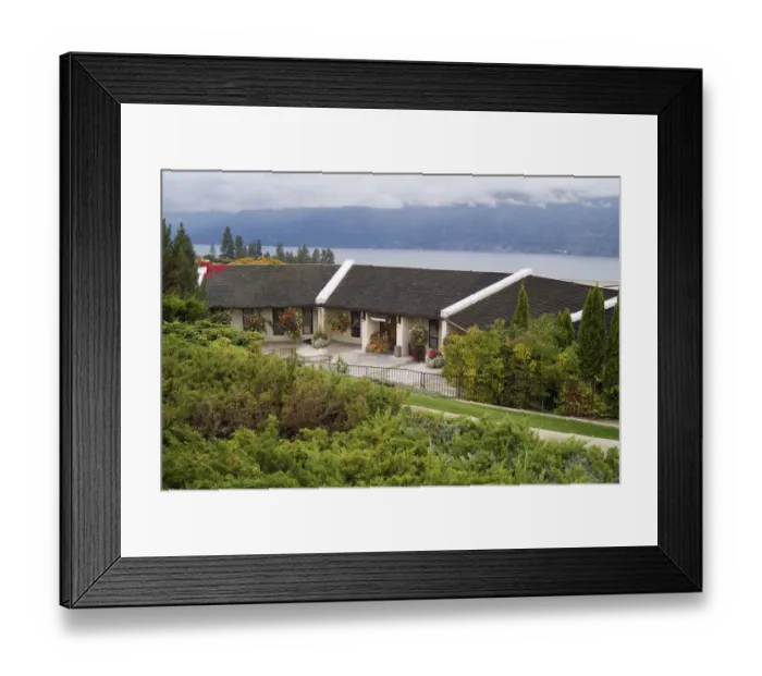 Framed Print : The wood-shingle roofed Grey Monk Estate Winery sits on the steep hills that slope Framed Print : The wood-shingle roofed Grey Monk Estate Winery sits on the steep hills that slope
