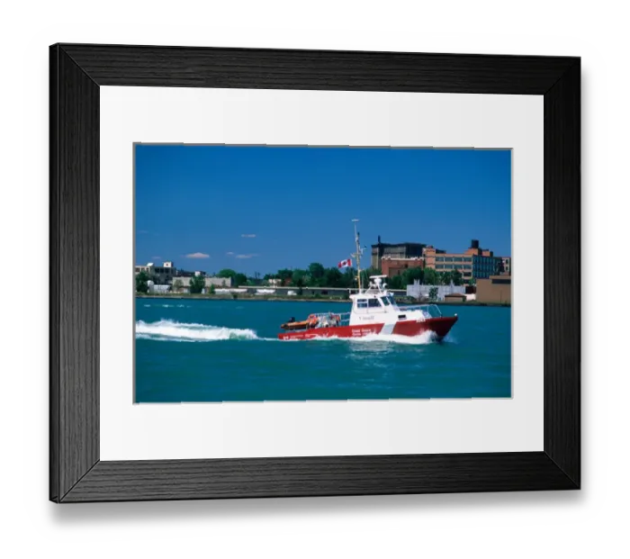 Framed Print : A Canadian coastguard boat patrols the Detroit River between Michigan and Windsor Framed Print : A Canadian coastguard boat patrols the Detroit River between Michigan and Windsor
