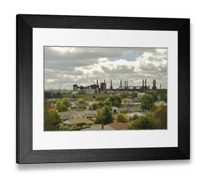 Framed Print : North America, Canada, Quebec, Mauricie. View of an aluminum plant past the roofs