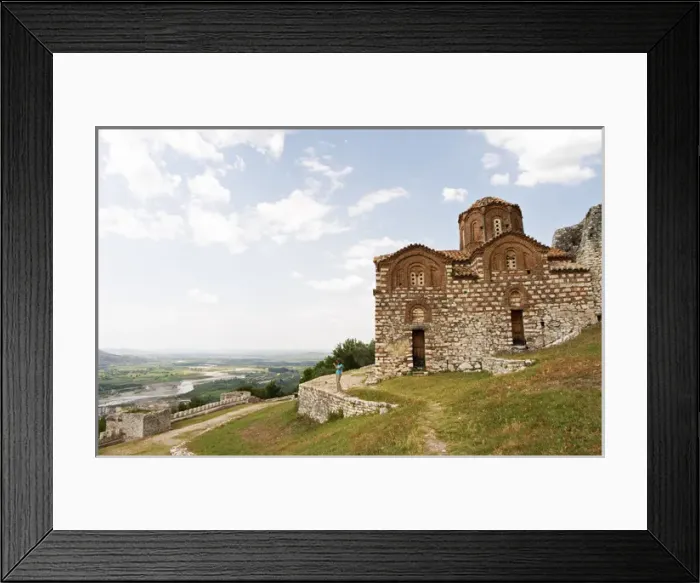 Framed Print : The Hagia Triada Church. View over the valley. A woman standing on a wall taking a photograph