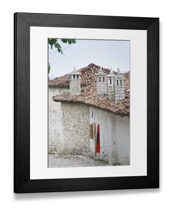 Framed Print : Narrow cobble stone street with traditional ottoman white stone houses. An Albanian