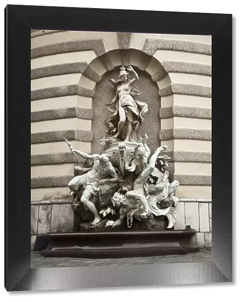 Vienna, Austria - Low angle view of a statue of three beings of a mythological nature