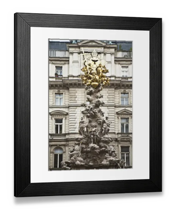 Framed Print : Vienna, Austria - Low angle view of an ornate religious sculpture in front of an old world building