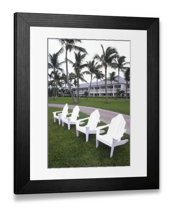 Framed Print : Classic white Adirondack chairs at the Elegant Ocean Club in Paradise Islands Bahamas