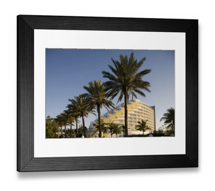 Framed Print : Bahamas, Grand Bahama Island, Freeport, Setting sun lights exterior and palm trees Framed Print : Bahamas, Grand Bahama Island, Freeport, Setting sun lights exterior and palm trees