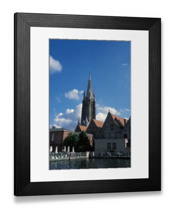 Framed Print : Europe, Belgium, Bruges. Church of our Ladys towering spire above the canals Framed Print : Europe, Belgium, Bruges. Church of our Ladys towering spire above the canals