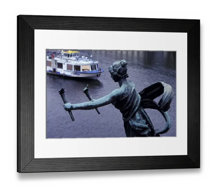 Framed Print : Europe, Czech Republic, Prague. Statue on Cechuv Bridge with cruise boat in background Framed Print : Europe, Czech Republic, Prague. Statue on Cechuv Bridge with cruise boat in background
