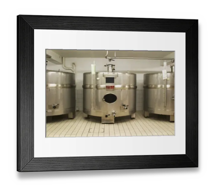 Framed Print : Stainless steel fermentation tanks of an unusual shape wider than they are high