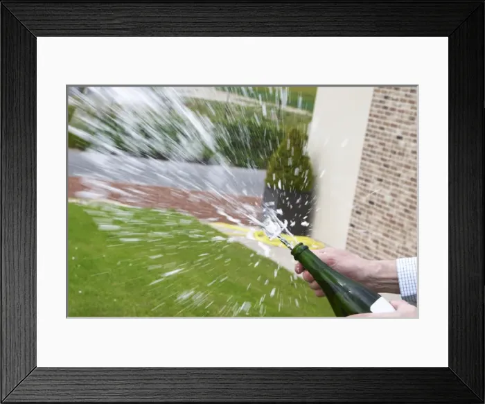 Framed Print : Herve Jestin, oenologist and chief winemaker holding a bottle of champagne Beuverie