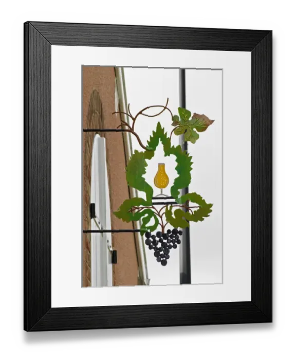 Framed Print : A wrouight iron painted sign that illustrates the theme of champagne and wine production Framed Print : A wrouight iron painted sign that illustrates the theme of champagne and wine production