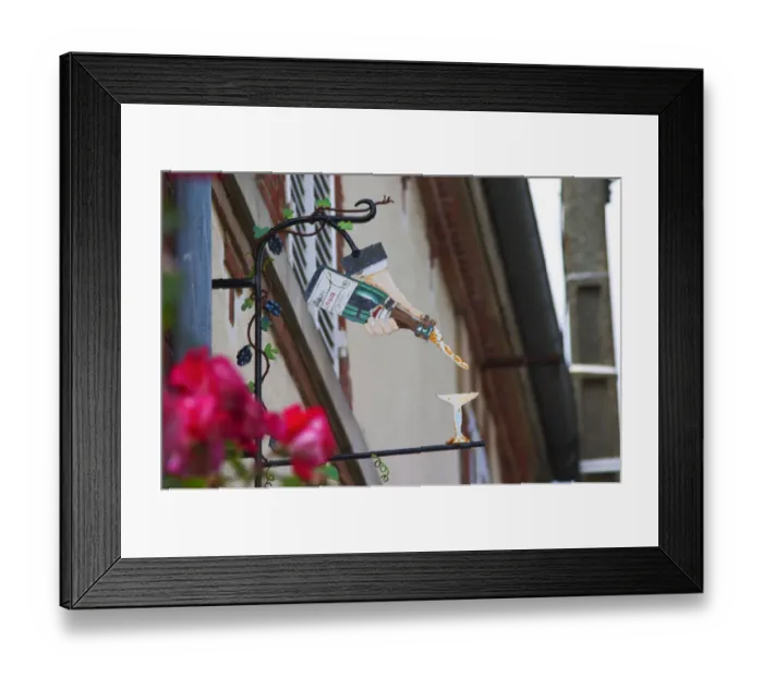Framed Print : A wrouight iron painted sign that illustrates the theme of champagne and wine production Framed Print : A wrouight iron painted sign that illustrates the theme of champagne and wine production