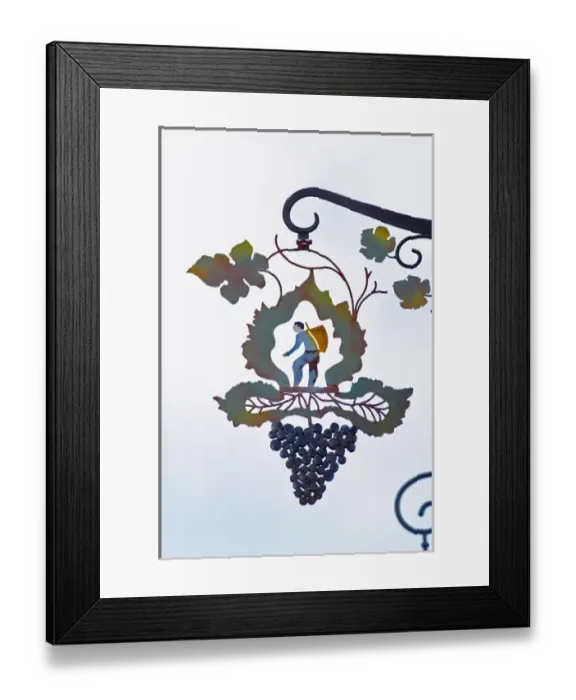 Framed Print : A wrouight iron painted sign that illustrates the theme of champagne and wine production