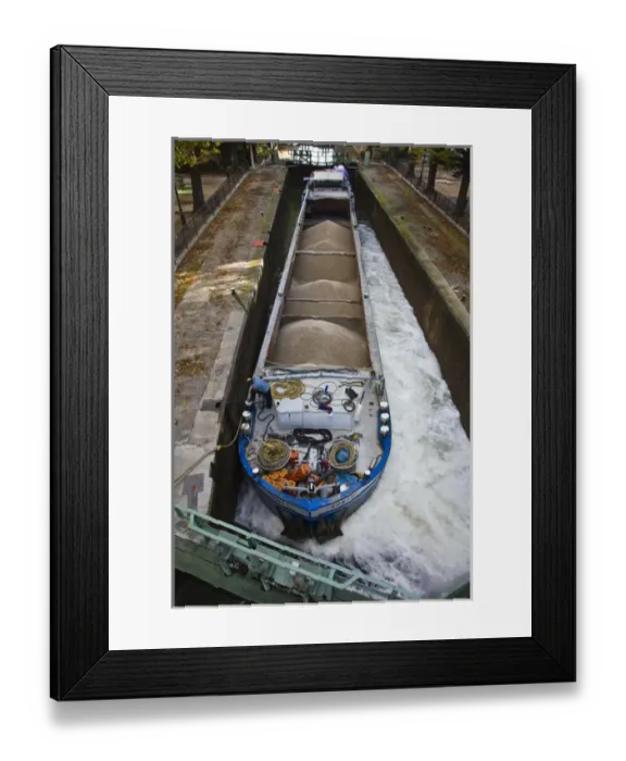 Framed Print : France, Paris, Canal St-Martin, barge and bargeman (NR) in canal locks by the Quai Framed Print : France, Paris, Canal St-Martin, barge and bargeman (NR) in canal locks by the Quai