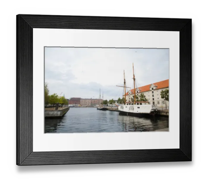 Framed Print : Copenhagen, Denmark - On old world, waterfront city. A boat are viewable on the water Framed Print : Copenhagen, Denmark - On old world, waterfront city. A boat are viewable on the water