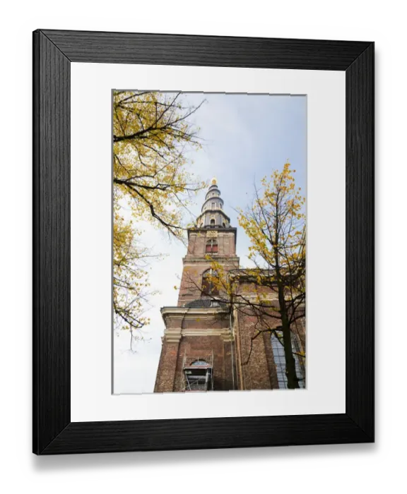 Framed Print : Copenhagen, Denmark - Low angle view of an ornate spire on an old world church. Vertical Framed Print : Copenhagen, Denmark - Low angle view of an ornate spire on an old world church. Vertical