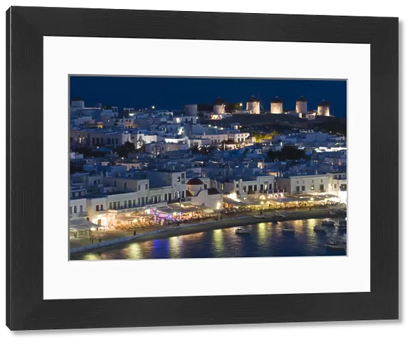 Europe, Greece, Mykonos, Hora. Night view overlooking harbor with illuminated windmills