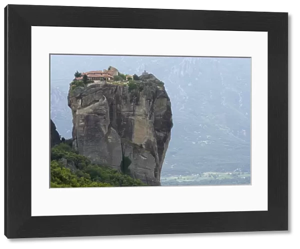 Europe, Greece, Meteora. Agias Triados Monastery perched atop rock pillar. Credit as