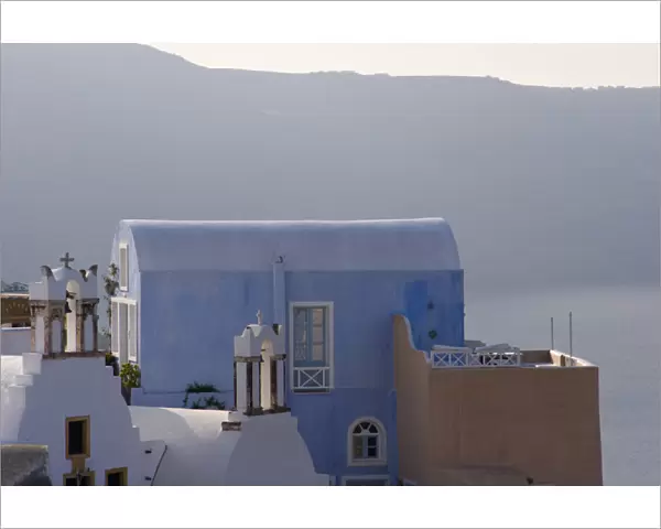 Europe, Greece, Santorini, Thira, Oia. Villa and patio with cliffs in distance. Credit as